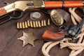 Wild west guns, ammunition and marshal badge with silver dollars