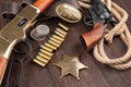 Wild west guns, ammunition and marshal badge with silver dollars