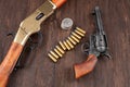 Wild west guns and ammunition with silver dollars Royalty Free Stock Photo