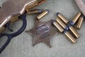 Wild west rifle, ammunition and sheriff badge Royalty Free Stock Photo