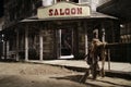 Wild west saloon front with hitch rack at night