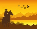 wild west sunset desert scene with cowboy in horse and gulls flying Royalty Free Stock Photo