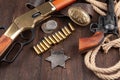 Wild west weapons, ammunition and sheriff badge with silver dollars