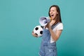 Wild woman football fan scream in megaphone, support favorite team with soccer ball isolated on blue turquoise Royalty Free Stock Photo