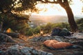 Wilderness campsite scene with a sleeping bag, backpack, and vintage lantern Royalty Free Stock Photo