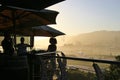 Terrace of a beach restaurant and guests in sunset light. South Africa.