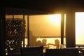 Terrace of a beach restaurant and guests in sunset light. South Africa.