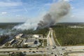 Wildfire burning severely during dry winter season in North Port city, Florida. Thick smoke rising up over suburb homes Royalty Free Stock Photo