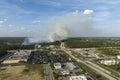 Wildfire burning severely during dry winter season in North Port city, Florida. Thick smoke rising up over suburb homes Royalty Free Stock Photo