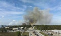 Wildfire burning severely during dry winter season in North Port city, Florida. Thick smoke rising up over suburb homes Royalty Free Stock Photo
