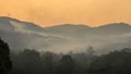 Wildfire disaster is burning forests on the mountains. Emergency services helicopter drops water to extinguish the forest fires Royalty Free Stock Photo