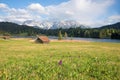 Wildflower meadow with marsh orchids, wooden barns, lake geroldsee and karwendel mountains