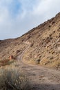 Desert Dirt Road Ascending Rocky Hillside