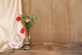 Wildflowers, red poppies in an old brass jug on an old wooden table, white silk drapery, the concept of the Dutch still life Royalty Free Stock Photo