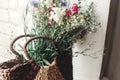 wildflowers in wicker bag on rustic white window. colorful flowers in brown basket in sunlight, space for text. rural atmospheric Royalty Free Stock Photo