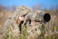 Wildlife photographer in the ghillie suit working Royalty Free Stock Photo