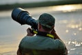 Wildlife photographer outdoor, standing in the water