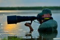 Wildlife photographer outdoor, standing in the water Royalty Free Stock Photo