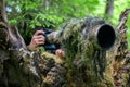 Wildlife photographer in the summer ghillie camouflage suit