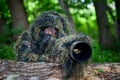 Wildlife photographer in the summer ghillie camouflage suit