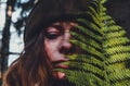 Portrait of a mysterious young girl posing alone in the autumn forest