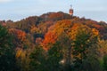 The Wilhelmina tower popping out of the forest in the dutch City of Valkenburg which is wonderful coloured in warm Autumn colours Royalty Free Stock Photo