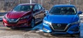 Wilkins Township, Pennsylvania, USA January 15, 2023 Two new Nissan sedans, one red and the other blue, for sale