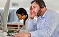 When will this day end. two business people working together in a call center. Royalty Free Stock Photo