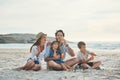 We will always have each other. Full length shot of a happy couple sitting with their two children who are blowing Royalty Free Stock Photo