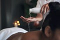 This will leave you feeling lighter and brighter. Closeup shot of a massage therapist pouring body oil into her hands Royalty Free Stock Photo