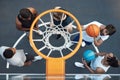Will he make the shot. High angle shot of a group of sporty young men playing basketball on a sports court. Royalty Free Stock Photo