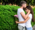 He will never let her go. Couple in love hugs on date in park green bushes background. Man fall in love with gorgeous Royalty Free Stock Photo