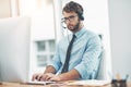 This will only take a moment...a young man working in a call center. Royalty Free Stock Photo