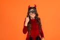 will terrify you. child celebrate autumn holiday. teenage girl in devil horns celebrate halloween. happy halloween
