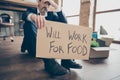 Will work for food. Closeup photo of despair unsuccessful worker mature aged fired agent lost job packed belongings box