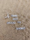 Will you marry me again written on sand at the beach with a beautiful silver engagement ring Royalty Free Stock Photo