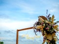 Will You Marry Me ?, LED neon light text hanging with flowers on the wooden poles on blue sky background. Royalty Free Stock Photo