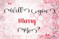 `Will you marry me?`on pink rose background.