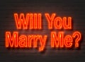 Will You Marry Me, red neon sign on brick wall