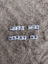 Will you marry me words written on sand at the beach Royalty Free Stock Photo
