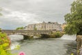 William O`Brien stone bridge over the Corrib river with flowing water and water entering the river through a small waterfall Royalty Free Stock Photo