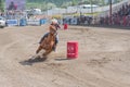 Cowgirl and horse take tight turn around barrel at barrel racing competition Royalty Free Stock Photo
