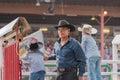 Man and two boys watch from behind the chutes at the Williams Lake Stampede