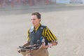 Cowboy stands read with saddle at Wild Horse Race Royalty Free Stock Photo