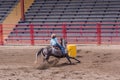 A cowgirl cuts around a barrel in a barrel racing event Royalty Free Stock Photo