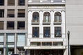 The Williams Sonoma building with tall black light posts, brown wood trim around the windows and gold letters at Union Square