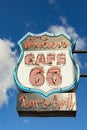 Route 66 cafe neon sign for a bar and grill under clear blue sky in Williams