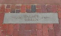 Williamsburg, Virginia - June 30, 2020 - A brick walkway with a sign towards Palace Green