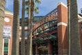 Willie Mays Gate at Oracle Park with tall lush green palm trees and blue sky in San Francisco California
