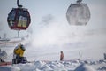 Willingen, Germany - February 7th, 2018 - Ski run with gondola lift and snow cannon shooting clouds of powdery snow Royalty Free Stock Photo